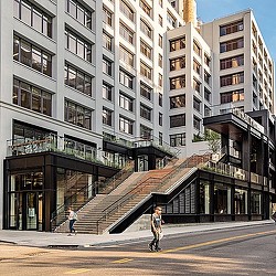 A person walking on a street next to a building.