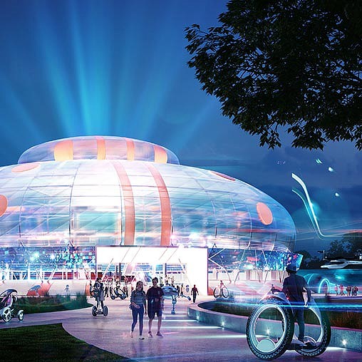 A large colorful building with a ferris wheel in the background.