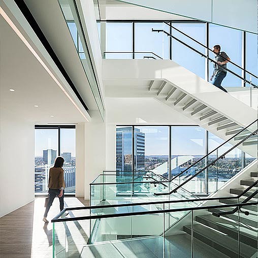 A couple of people walking up a staircase.