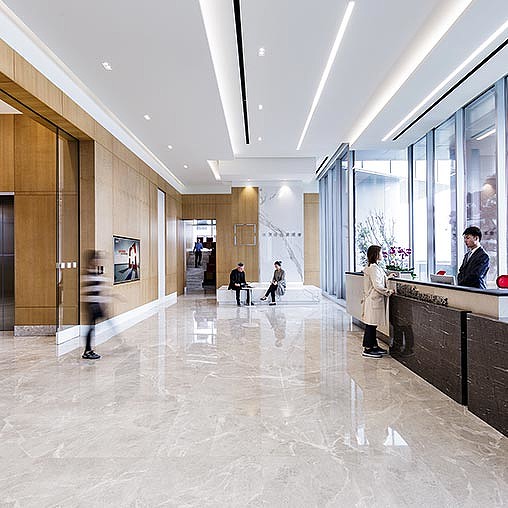 A long hallway with people and glass doors.