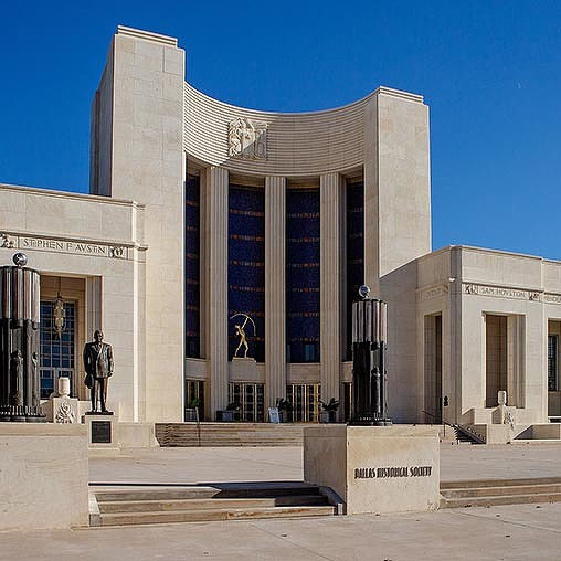 A building with a statue in front.