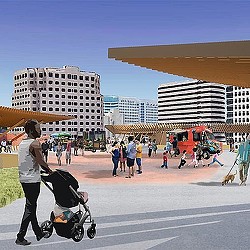 A man walking with a stroller in a baseball stadium.