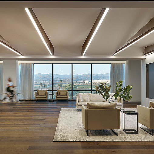 A room with a large window and a large body of water.