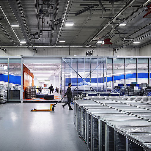 A person walking in a large warehouse.