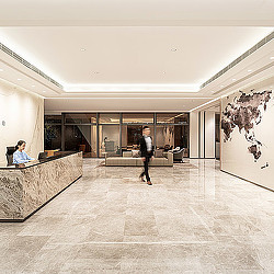 A person walking in a large office.