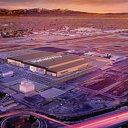 A large stadium with a field in the background.