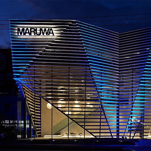 Maruwa R&D Center exterior lit up at night.