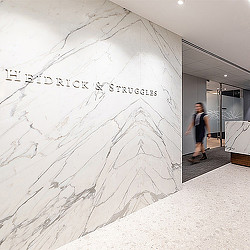 A man standing next to a large white sculpture.