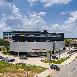 A large building with a parking lot.