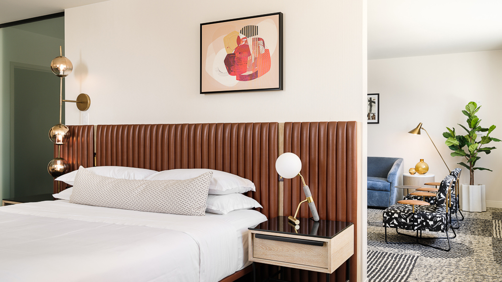 A bedroom with a bed and a chair.