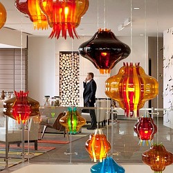 A person standing next to a display of vases.