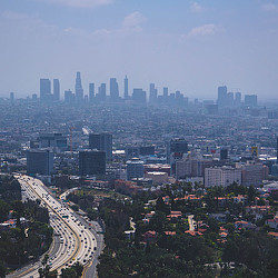 A city with a freeway and buildings.