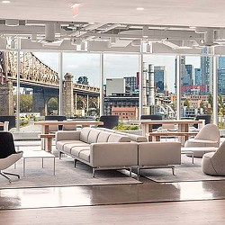 A room with a large window and a couch.