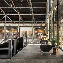 A large room with a staircase and plants.