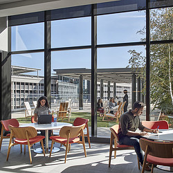 People sitting at tables outside.