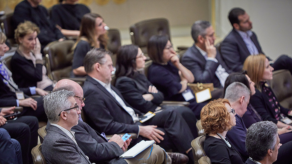 A group of people sitting in chairs.