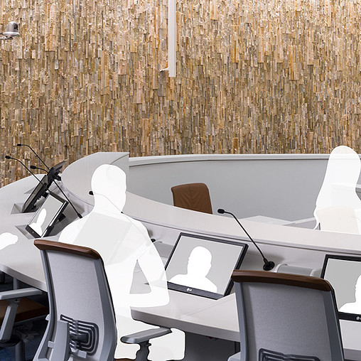 A group of people sitting at desks with laptops.