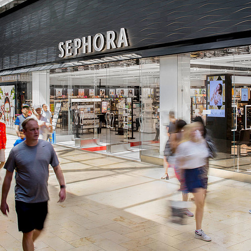 A group of people walking in a mall.