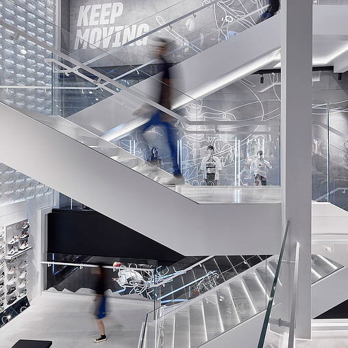 A person walking down a escalator.