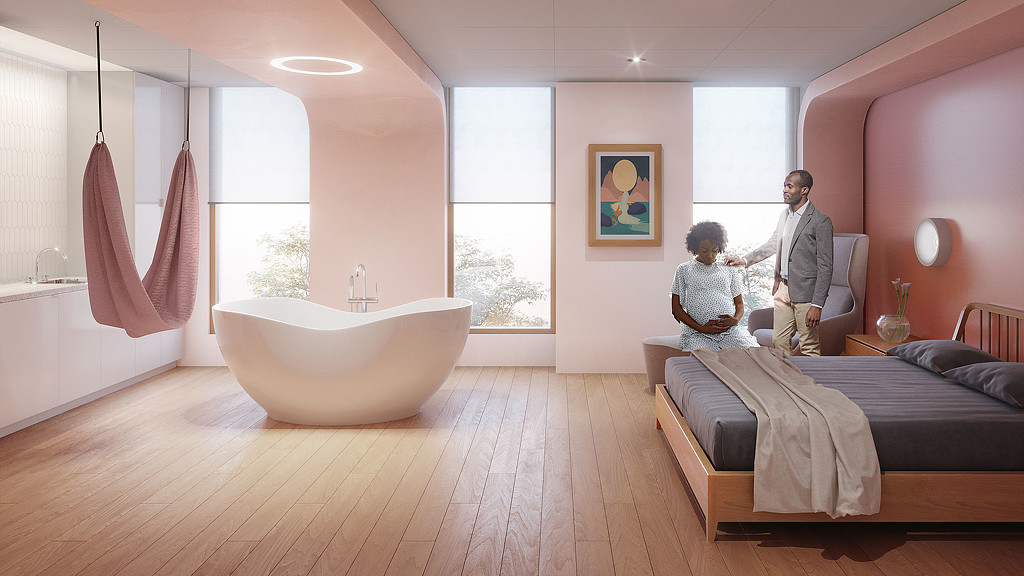 A man and a woman in a room with a tub and a large window.