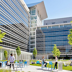 A few people outside of a building.