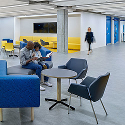 A man and a woman sitting in a waiting room.