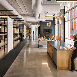 A long hallway with a desk and chairs.