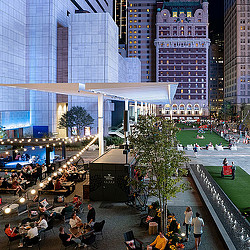 A group of people sitting outside a building.