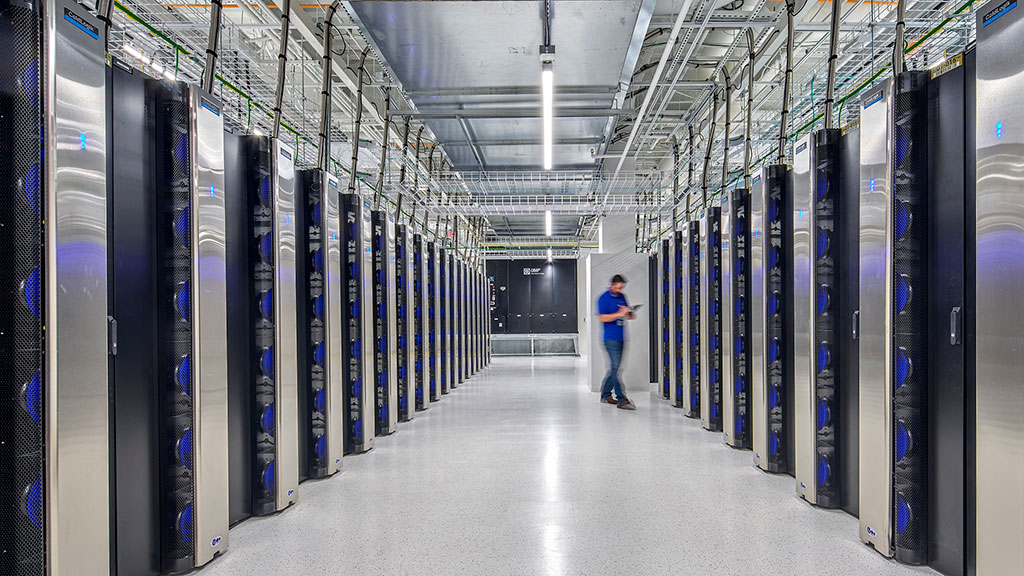 A person walking in a server room.