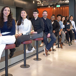A group of people sitting on a bench.