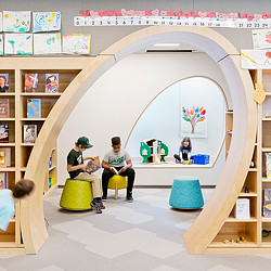 A group of people sitting in a room with a slide.