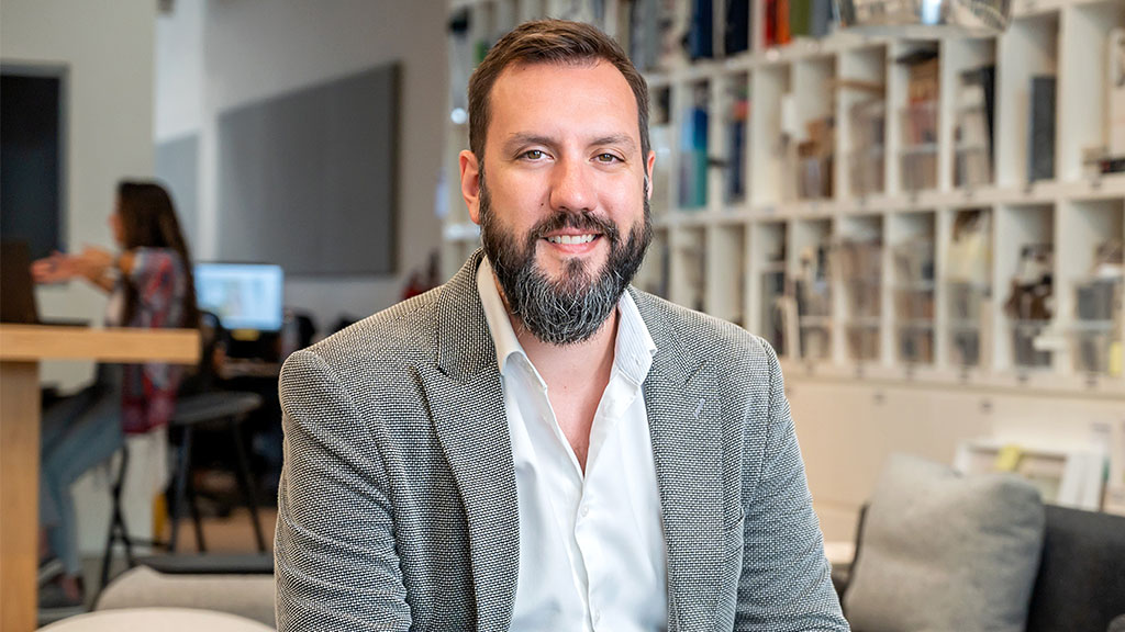 A man with a beard smiling.