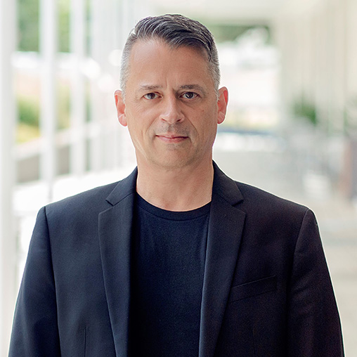 A man in a black suit.