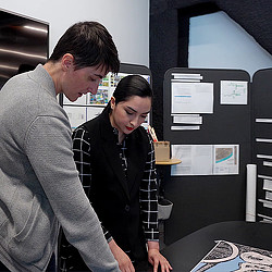 Two Gensler Houston employees working on a project