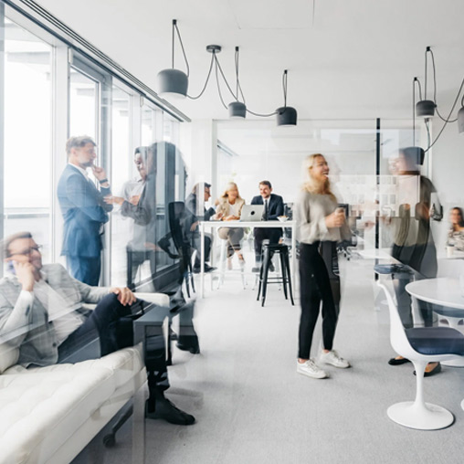 Employees mingling in office. Photo via Getty Images/Washingtonian.