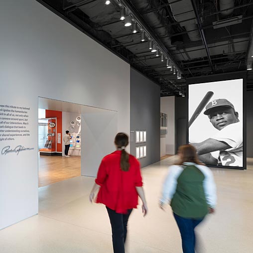 A couple of women walking in a museum.
