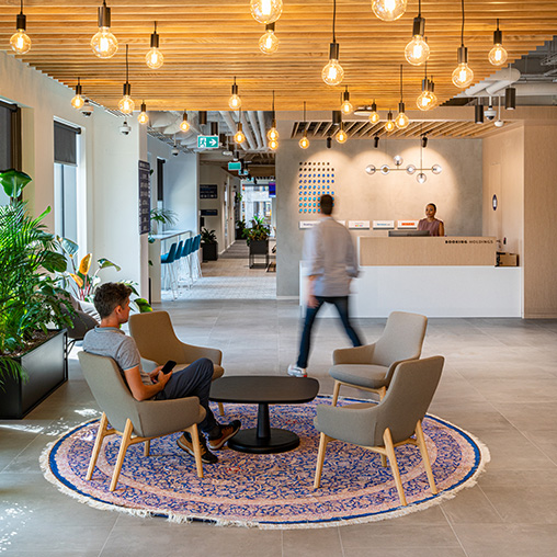 Booking Holdings reception with lounge seating and hanging lights.
