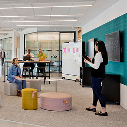 A person standing in front of a whiteboard.
