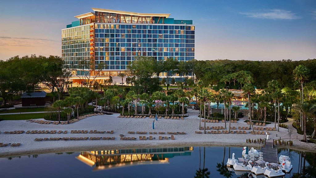 A building with a pool and boats in front of it.