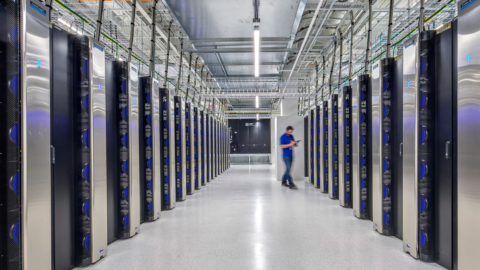 A person walking in a server room.