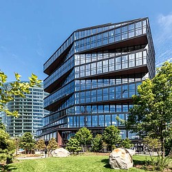 Exterior shot of 111 Harbor Way with trees, grass, and a walkway