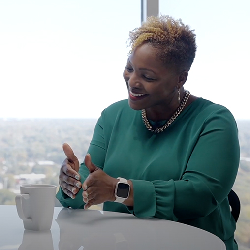 Karla Sherrell seated at a table in conversation