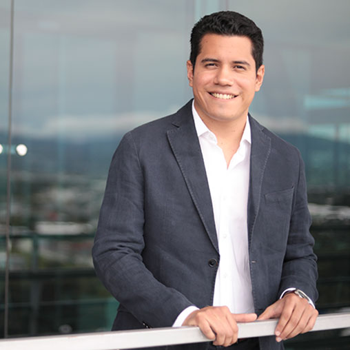 A man in a suit smiling.