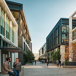 A person sitting on a bench in a city.
