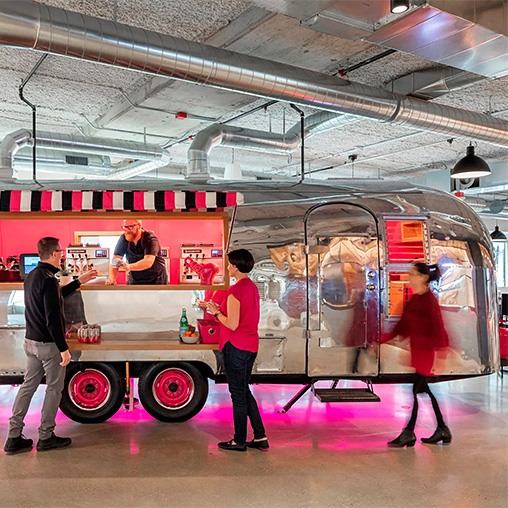 People standing in front of a food truck.