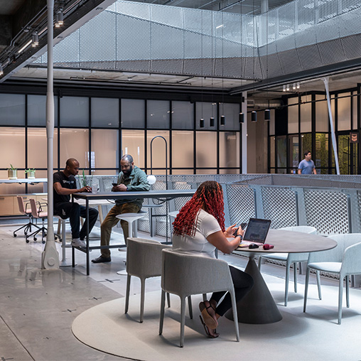 People working at tables inside the Ion