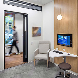 A person walking to get treatment at a modern healthcare facility.