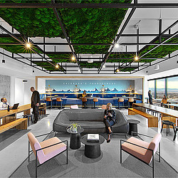 A room with tables and chairs and people in it.