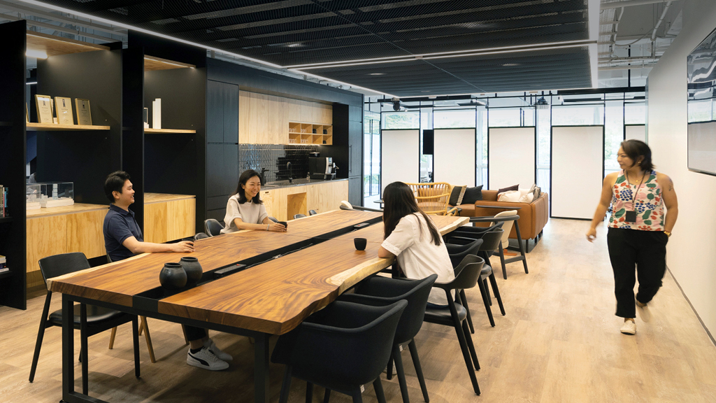 A group of people sitting at a table in a room.
