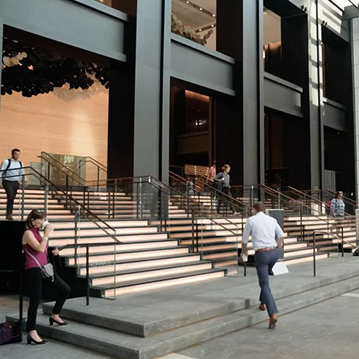 People walking up Willis Tower lobby stairs
